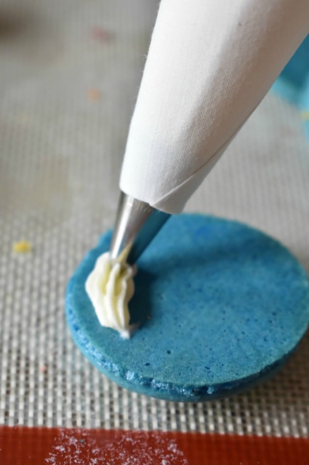 Piping the filling in a Macaron