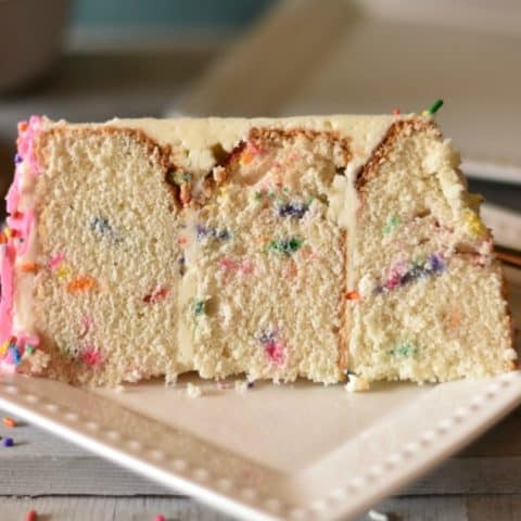 A slice of three layer funfetti cake