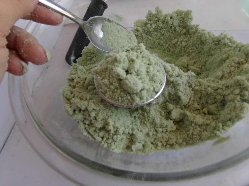 Adding mixture to bath bomb molds