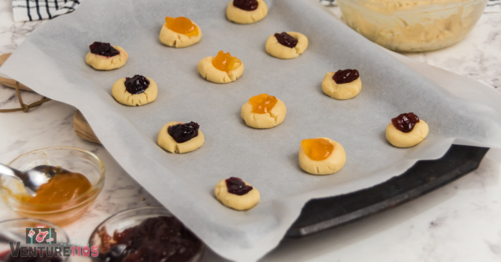 Thumbprint cookies on a baking sheet 