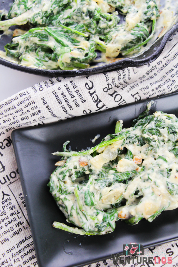 Creamed spinach on a black plate