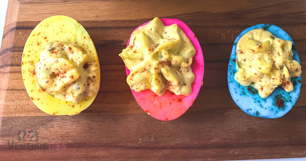 A yellow, pink, and blue deviled egg