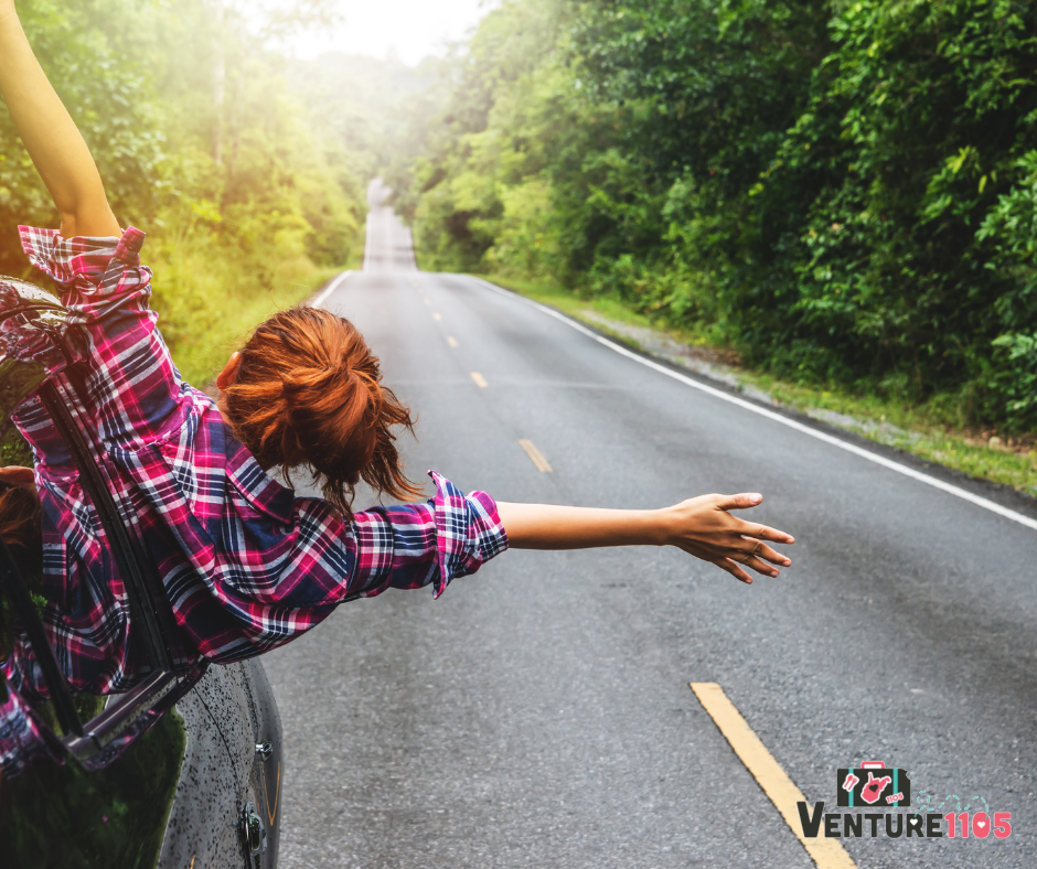 A girl with red hair outside her car window