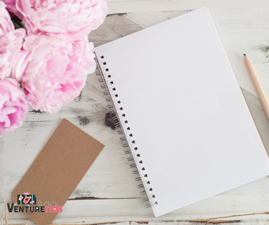 A notebook, pencil, and flowers 