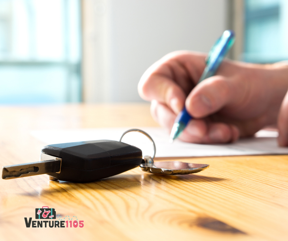keys on a desk while a person fills out paperwork 