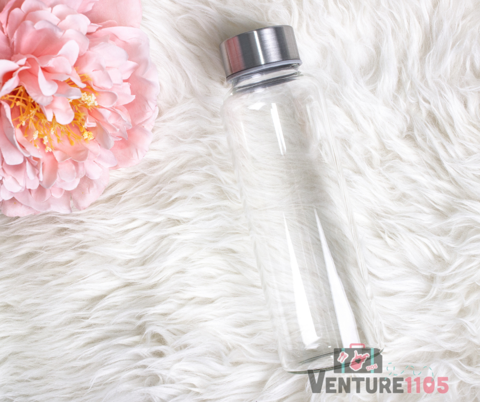 A reusable water bottle on a white furry rug 