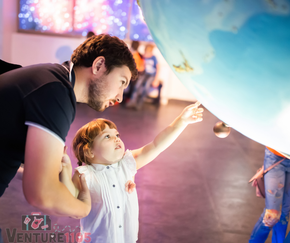 A child at a museum with her dad