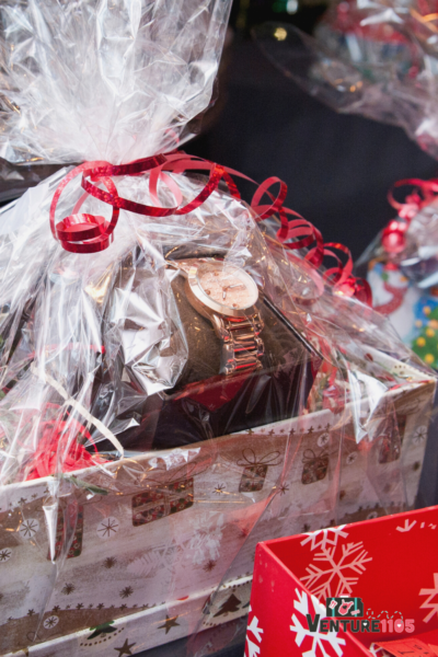 a gift basket with a watch inside of it