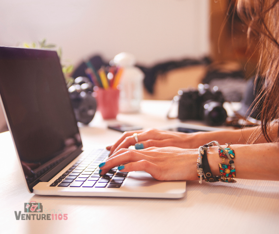 A writer typing at a laptop