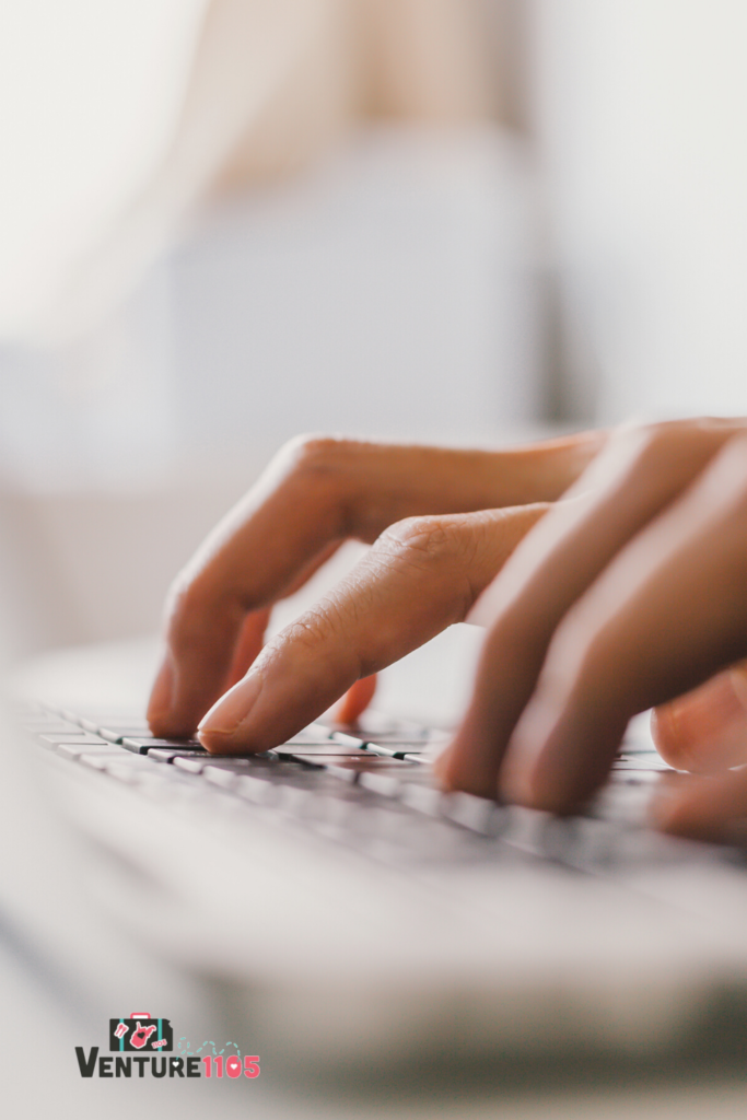 A close-up of hands typing on a keyboard