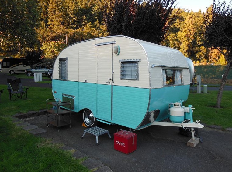 A blue and white camper trailer 