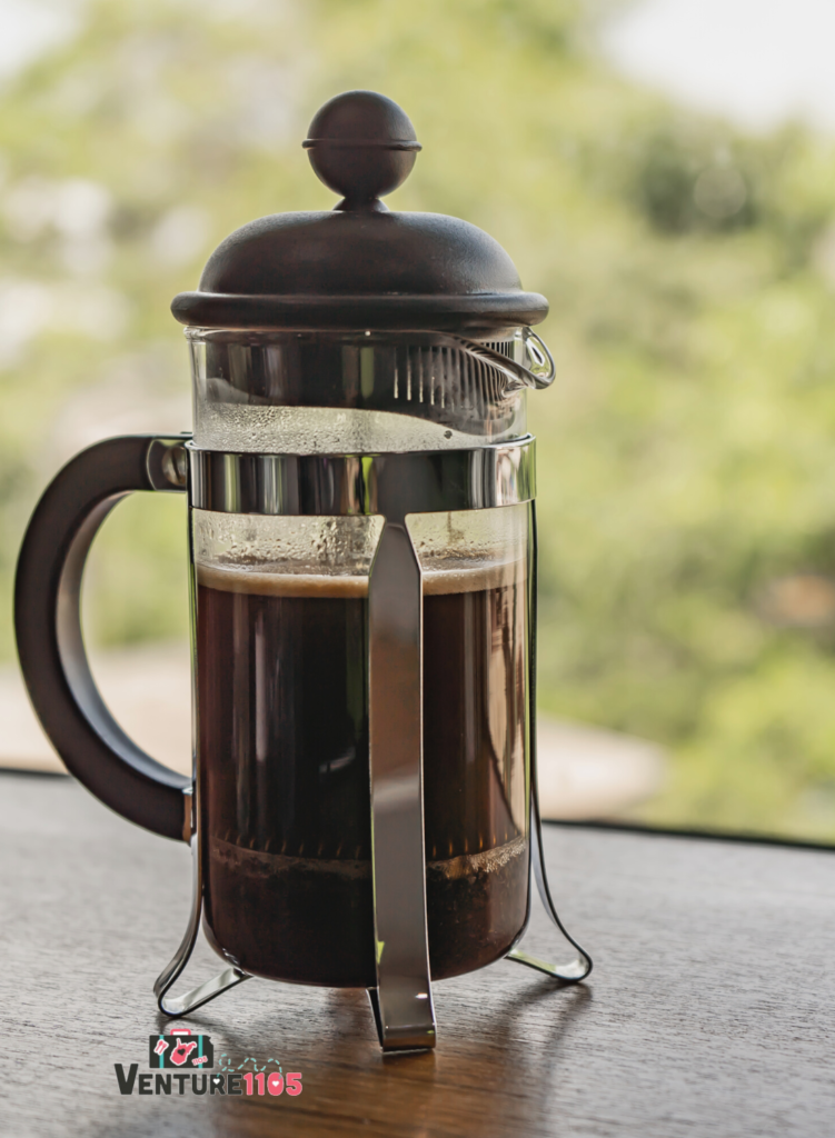 A French Press coffee pot full of freshly brewed coffee