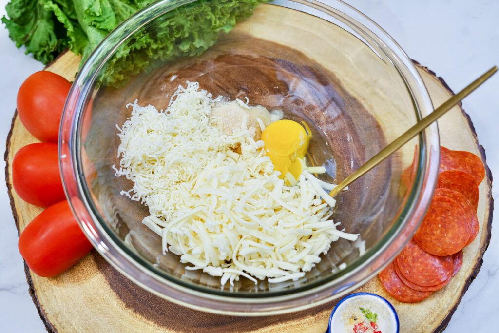 The ingredients for keto pizza crust in a mixing bowl