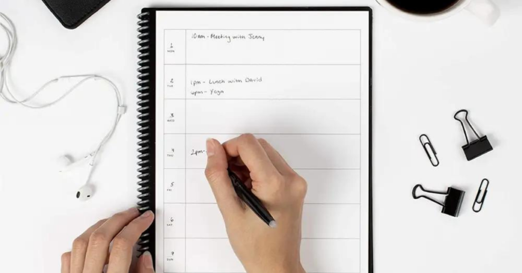 Someone writing in a smart notebook