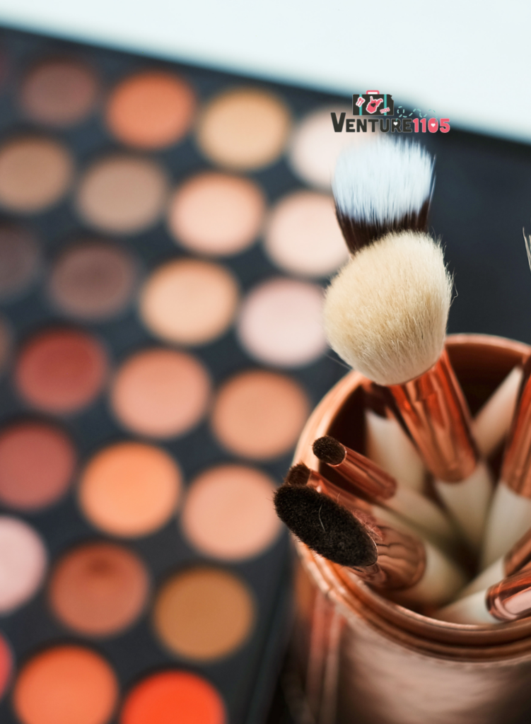 Makeup brushes next to a makeup palette.