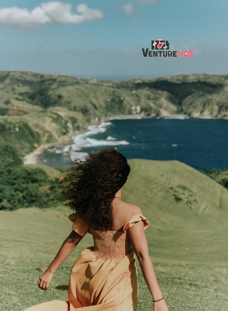 A woman looking at a beach and lake with wanderlust 