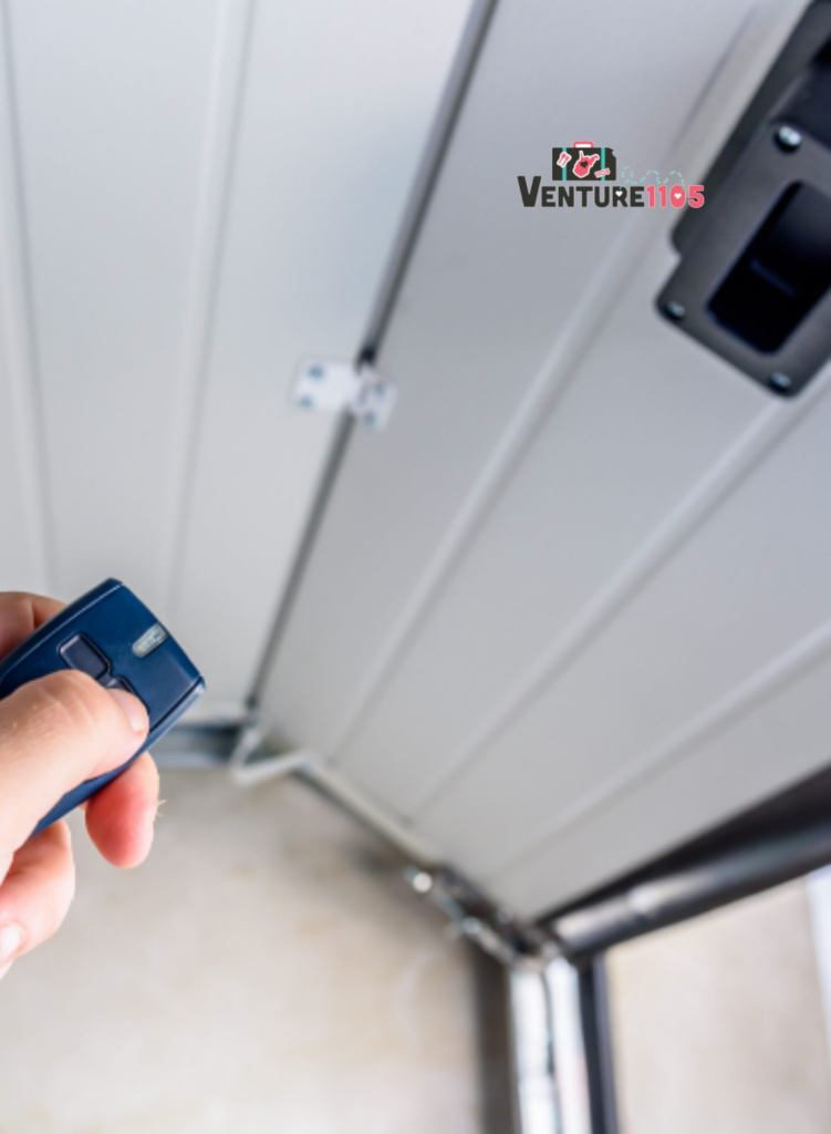 A person using a garage door clicker to open the garage door