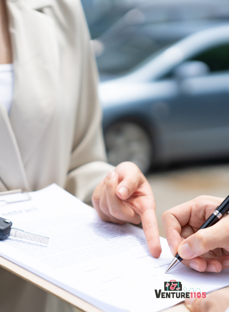 A person signing a rental car contract